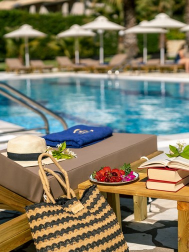 Enjoying some fruit and a book by the pool