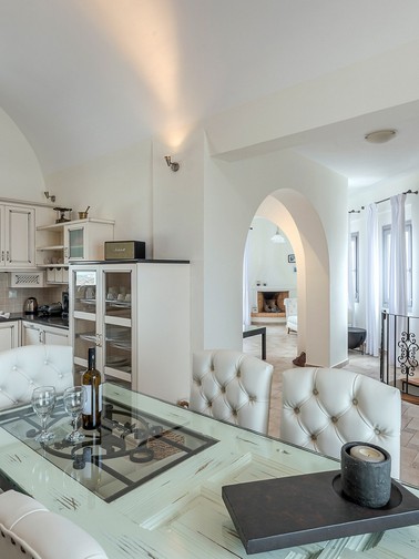 Upper-level dining table and kitchen counter in the background