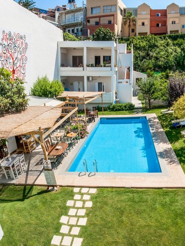 Hotel exterior, pool, and pool bar