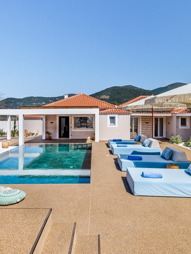 Pool, sunbeds, and villa entrance