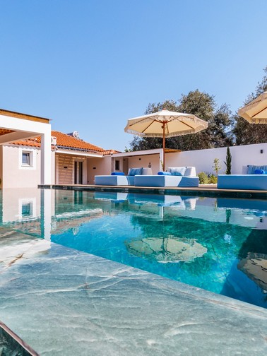 Pool, sunbeds, and villa entrance