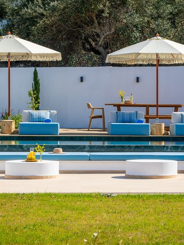 Pool, outdoor seating area and sunbeds