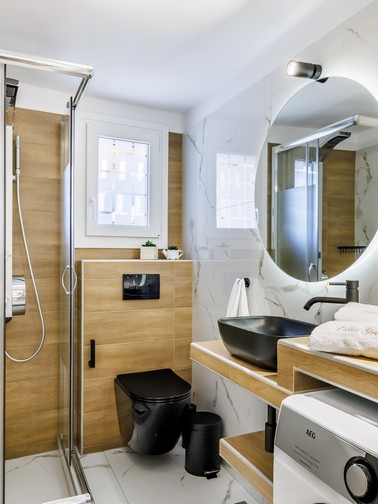 Bathroom with shower and washing machine