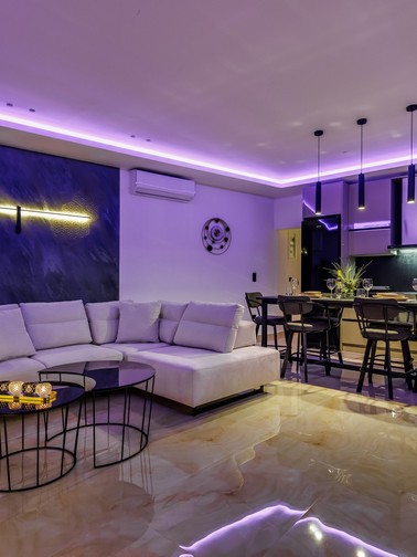 Sitting area, kitchen, and dining area by night