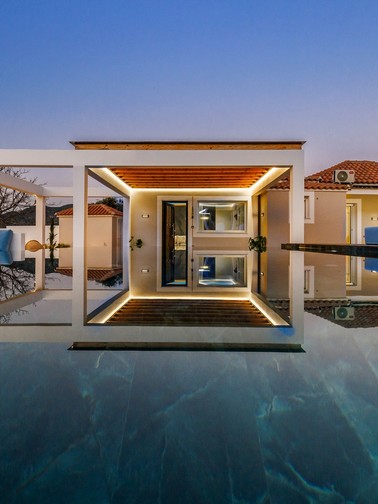 Pool and villa entrance at dusk