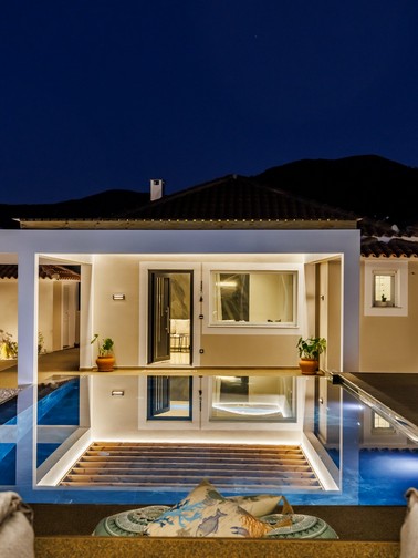 Pool and sunbeds by night