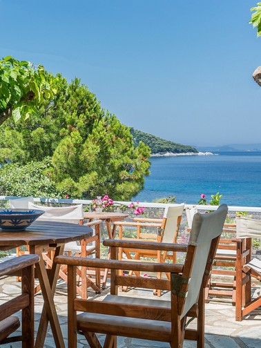 Shaded outdoor seating area overlooking the sea