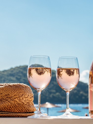 A couple of glasses of local wine and a weaved fedora